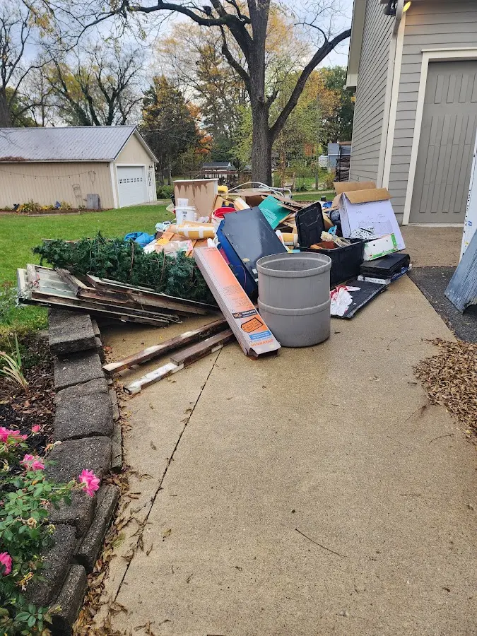 Dumpster being loaded with debris for Estate Cleanout Dumpster Rental in Shannon Hills